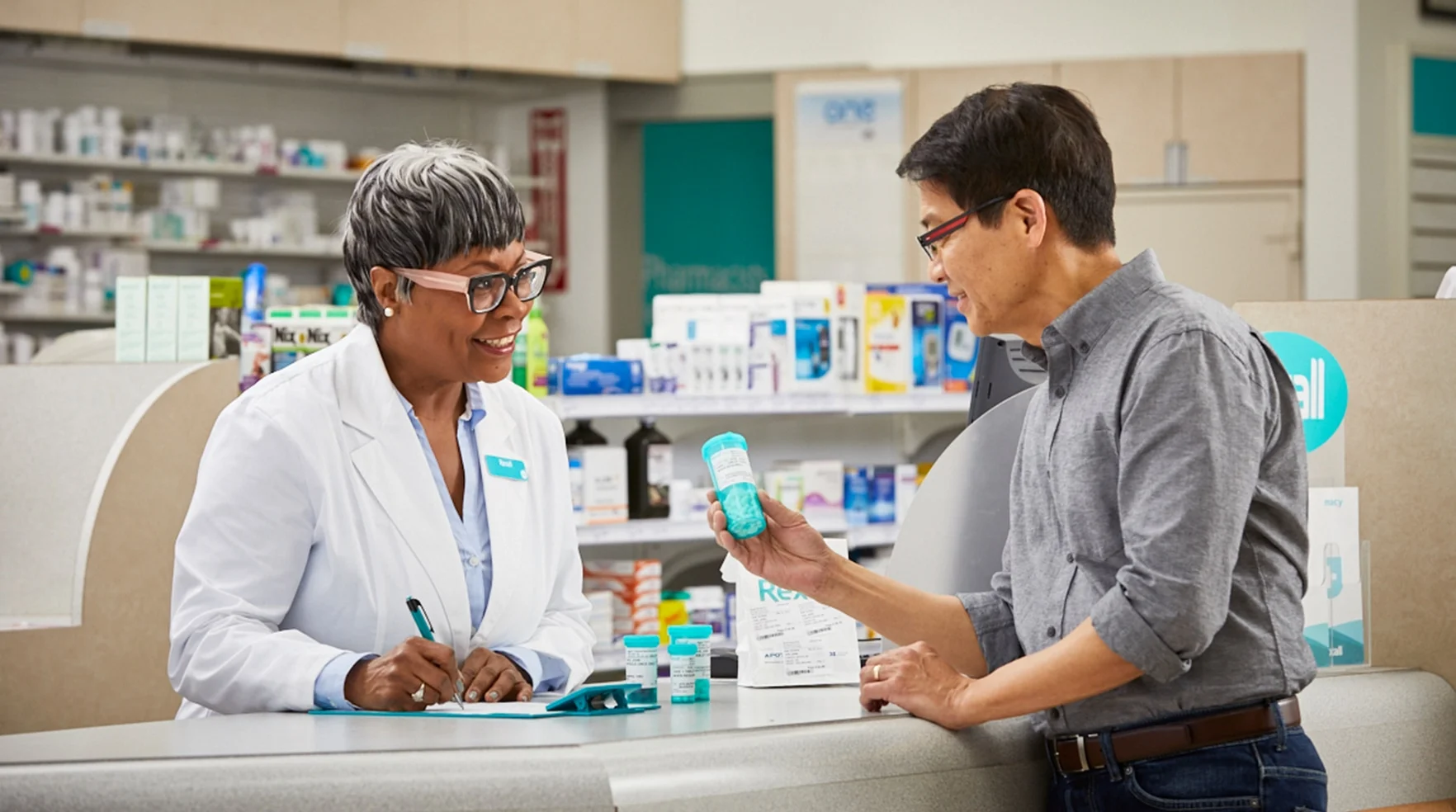 Rexall pharmacist helping a customer