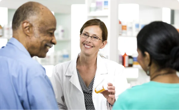 A Rexall pharmacist speaking with a customer